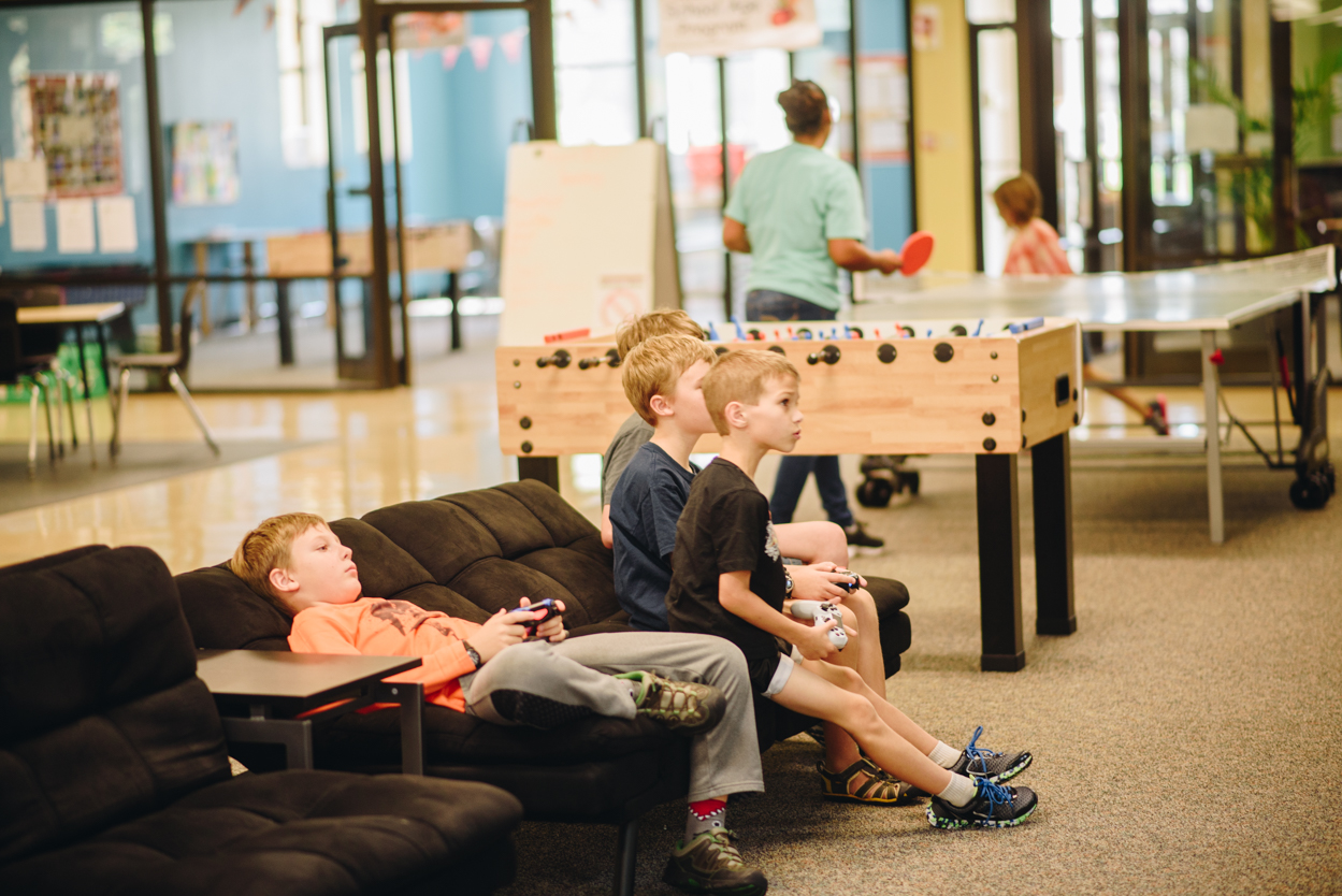 boys sitting on a couch playing video games