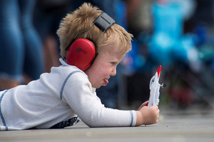 kid playing with a toy airplane