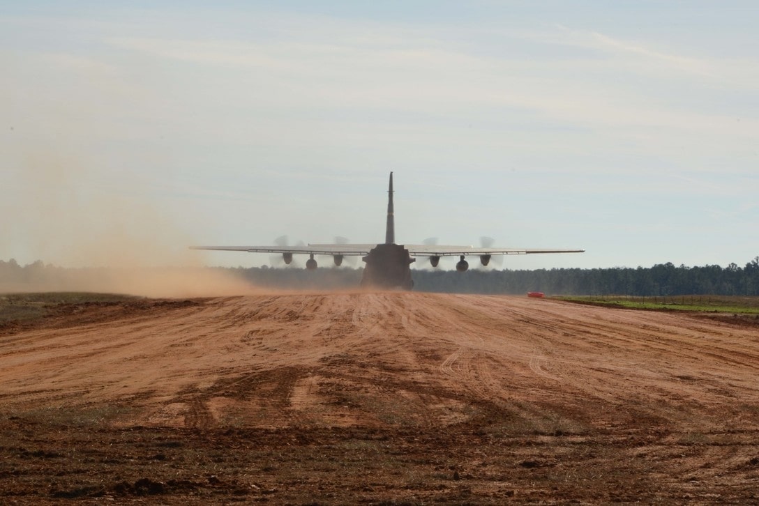 C130 aircraft on a dirt runway