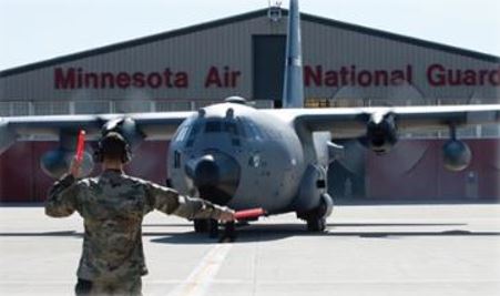 Airman marshaling a C130
