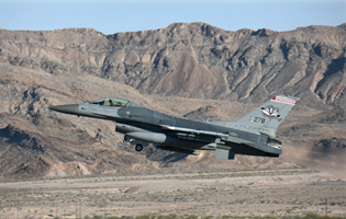F16 flying with mountains in the background